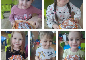 Dzieci prezentują do zdjęcia wykonane z papieru pączki