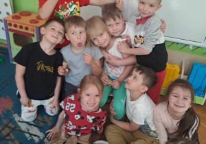 Dzieci pozują do zdjęcia z koleżanką, która obchodzi urodziny