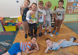 Chłopcy pozują do zdjęcia z kolegą który ma urodziny