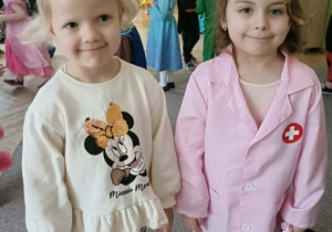 Dwie dziewczynki uśmiechają się do zdjęcia.