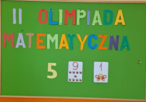 Tablica informacyjna z napisem II Olimpiada Matematyczna