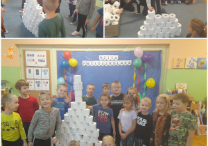 Grupa dzieci buduje piramidę z rolek papieru toaletowego