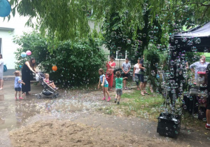 bańki mydlane w ogrodzie przedszkolnym, rodzice bawią się z dziećmi